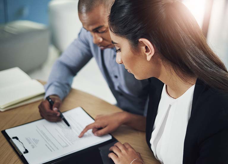 Business people going through paperwork in an office Business people going through paperwork in an office