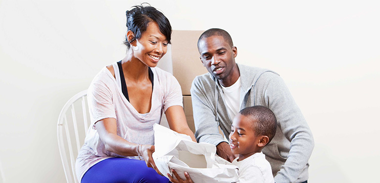 Little-boy-plays-in-box-with-his-parents Little-boy-plays-in-box-with-his-parents