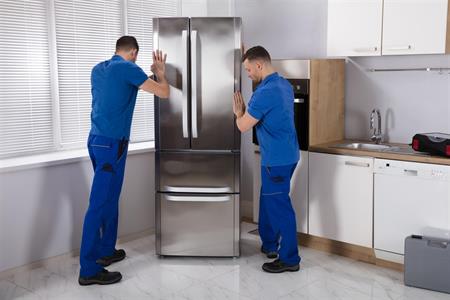 men installing refrigerator
