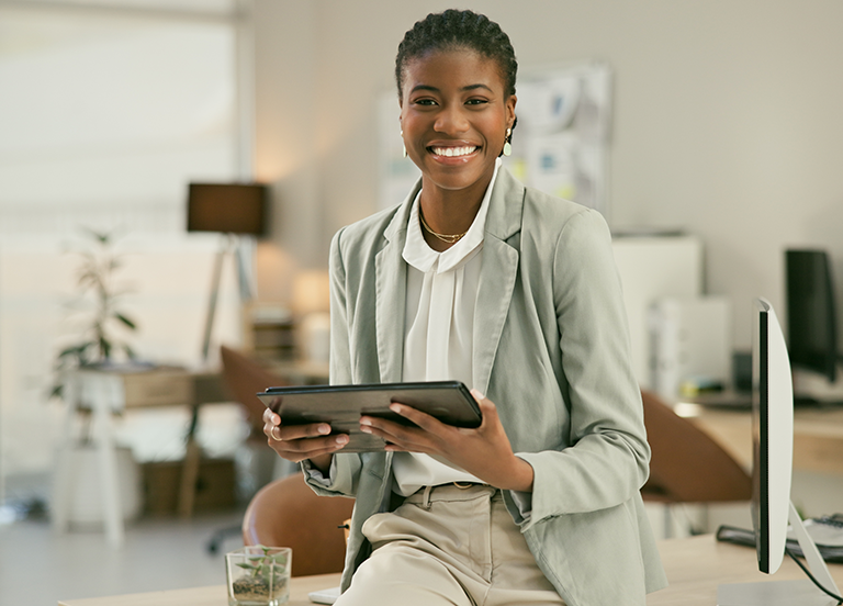 A professional in an office holding a tablet